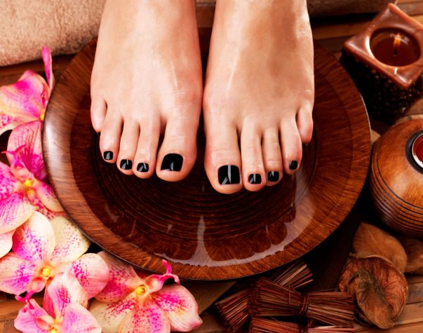 Beautiful women legs with black pedicure after Spa procedures - Spa treatment concept